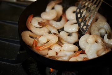 Grilling shrimps in frying pan