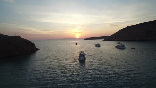 Aerial shot of the sunset in Partida Island with boats and yachts, Archipielago Espritu Santo National Park, Baja California Sur.