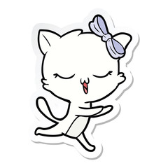 sticker of a cartoon cat with bow on head