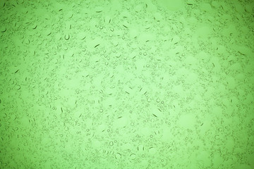 Rain droplets on green glass background, Water drops on green glass.