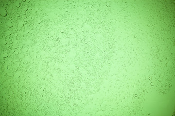 Rain droplets on green glass background, Water drops on green glass.