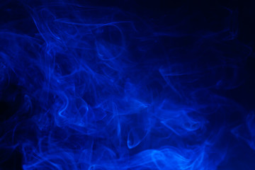 Blue smoke on black background.