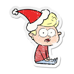 distressed sticker cartoon of a staring man wearing santa hat