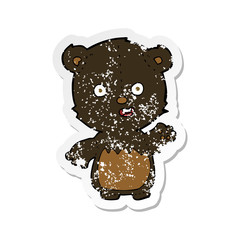 retro distressed sticker of a cartoon waving black bear cub