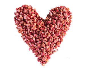 Plakat red heart made from corn seeds on a white background. Valentine's Day concept