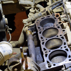 The cylinder block of the four-cylinder engine. Disassembled motor vehicle for repair. Parts in...