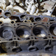 The cylinder block of the four-cylinder engine. Disassembled motor vehicle for repair. Parts in...