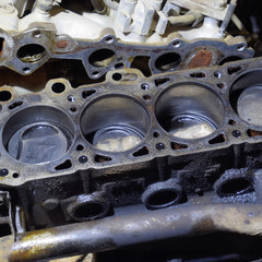 The cylinder block of the four-cylinder engine. Disassembled motor vehicle for repair. Parts in...