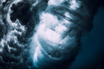 Powerful wave underwater with air bubbles. Ocean in underwater