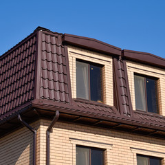 The house with plastic windows and a roof of corrugated sheet