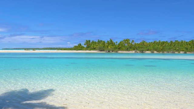 COPY SPACE: Gentle waves roll towards the stunning untouched white sand beach in the middle of the Pacific. Picturesque shot of paradise island beach and turquoise ocean in famous tourist destination.
