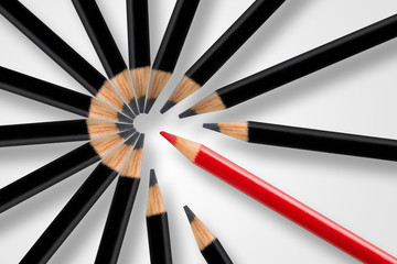Business concept of disruption, leadership or think different; red pencil breaking apart circle of black pencils