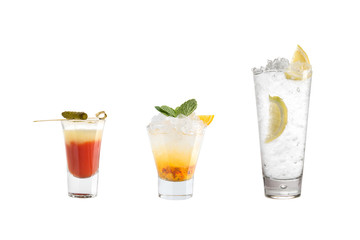 A variety of alcoholic drinks, beverages and cocktails on a white background. Three refreshing drinks in different glass goblets.