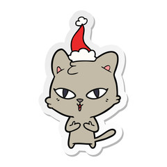 sticker cartoon of a cat wearing santa hat