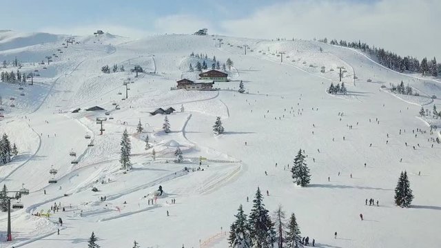 Drone Ski Slope snowy mountain with people. Flachau, Austria