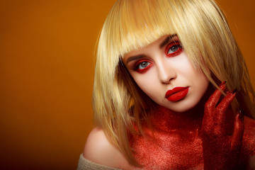 Red makeup in the style of beauty. Bright lips and eyes. Portrait of a beautiful young girl. Journal detailed skin retouching. Expressive eyebrows. Huge eyelashes. Neon shadows.