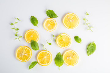Lemon slices and mint leaves on white background
