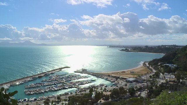 The marina of Sidi Bousaid and the Tunisian coast with sun reflection on the sea.