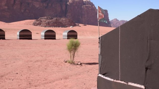 Jordan flag in wind Wadi Rum desert