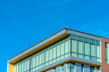 Sunlit exterior of a building against blue sky