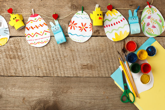 easter eggs garland on wooden vintage rustic background, copy space, flat lay