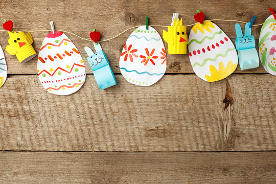 easter eggs garland on wooden vintage rustic background, copy space, flat lay