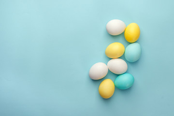 Easter eggs painted in pastel colors on blue background. Easter minimal concept, copy space