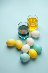 Painting Easter eggs minimal concept, colorful eggs on blue background, modern easter holiday diy
