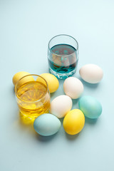 Painting Easter eggs minimal concept, colorful eggs on blue background, modern easter holiday diy