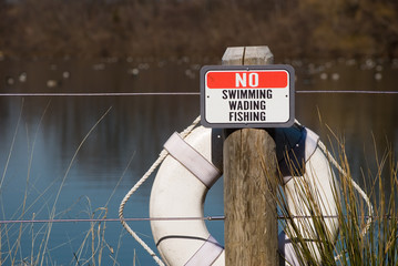 No Swimming Sign at Reservoir with life preserver