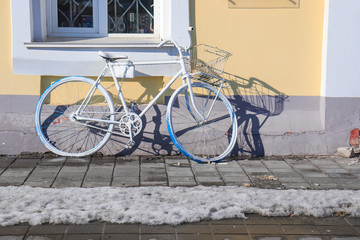 white bycycle at the wall