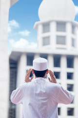Muslim man doing azan in the mosque