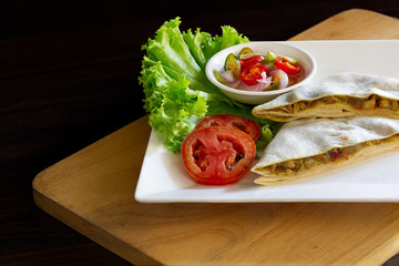Roti mataba and in white dish on wooden table Muslim food, Halal food and vegetable pickled sauce in cup on wooden chopping board