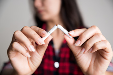 Soft focus of woman hand breaking, crushing or destroying cigarettes. World No Tobacco Day, May 31....