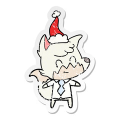 distressed sticker cartoon of a friendly fox wearing santa hat