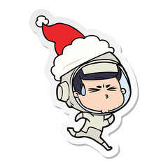sticker cartoon of a stressed astronaut wearing santa hat