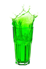 Green soda splashing out of glass isolated on white background.