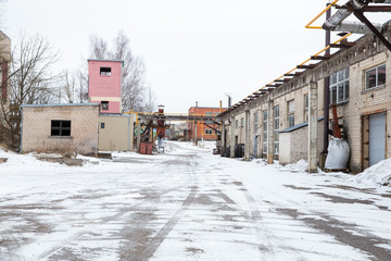 Old industrial factory and broken buildings. Snow and cold. Travel photo 2019.