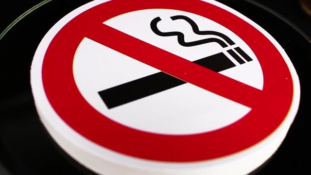 Don't smoking do not smoke sign closeup texture video on rolling rotating looping plate