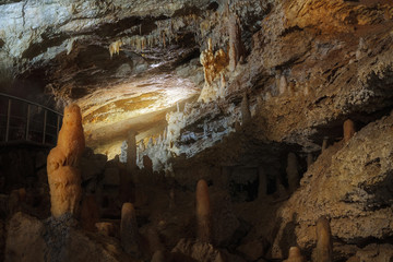 The cave is lit by artificial light