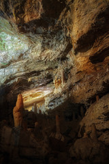 The cave is lit by artificial light