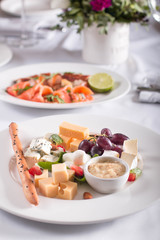 Beautifully decorated Banquet table with snacks, canapes, sandwiches, fresh vegetables, birthday, corporate event or wedding celebration