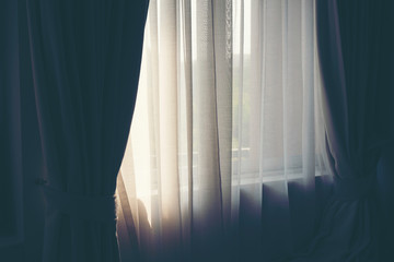 White curtains in a warm bedroom