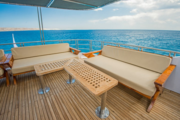Table and chairs on deck of a luxury motor yacht