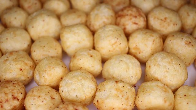 Millet ball gluten free balls closeup texture video on rolling rotating looping plate