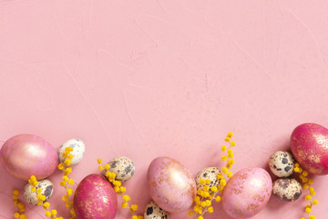 Background with various Easter eggs with golden spots and flowers