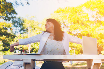 Business woman sitting on bench in park. She is smile relax time. Photo concept  business and comfort zone .