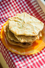 Fried tortillas on a rustic window on a towel