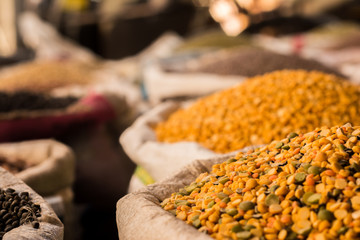 heap of lentils in sacks at a grocery shop