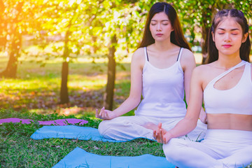 Group people have meditation for yoga.In the morning they are sitting on mat and play yoga in...